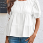 Top med puffärmar, smock och peplum